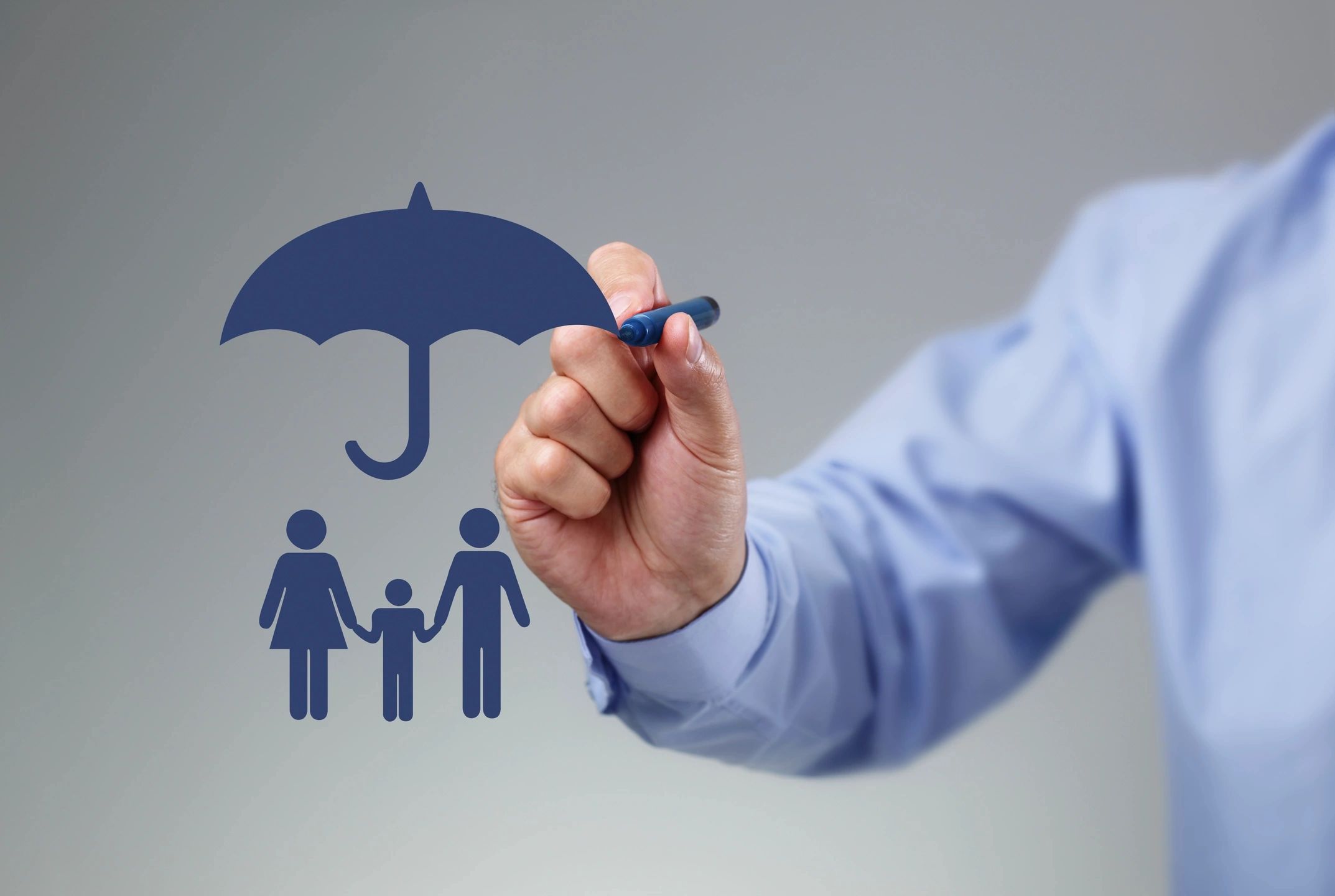 Hand drawing a blue umbrella protecting a family symbol.